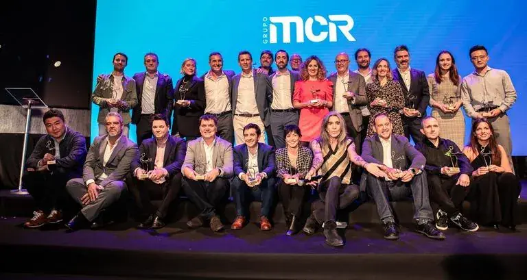 Foto de grupo de premiados en el escenario de una gala corporativa